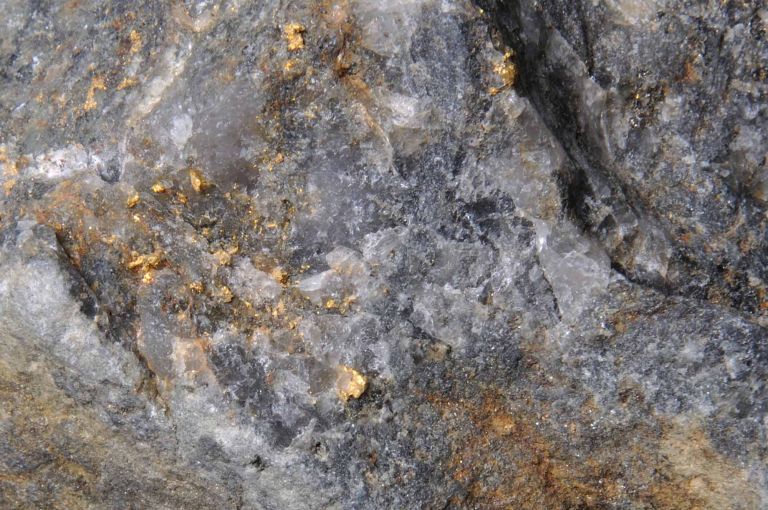 Background of natural gold in a piece of quartz from Australia