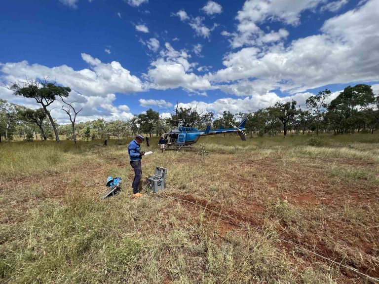 Man standing in front of a helicopter