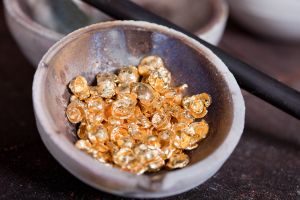 Close-up image of raw gold in a crucible.