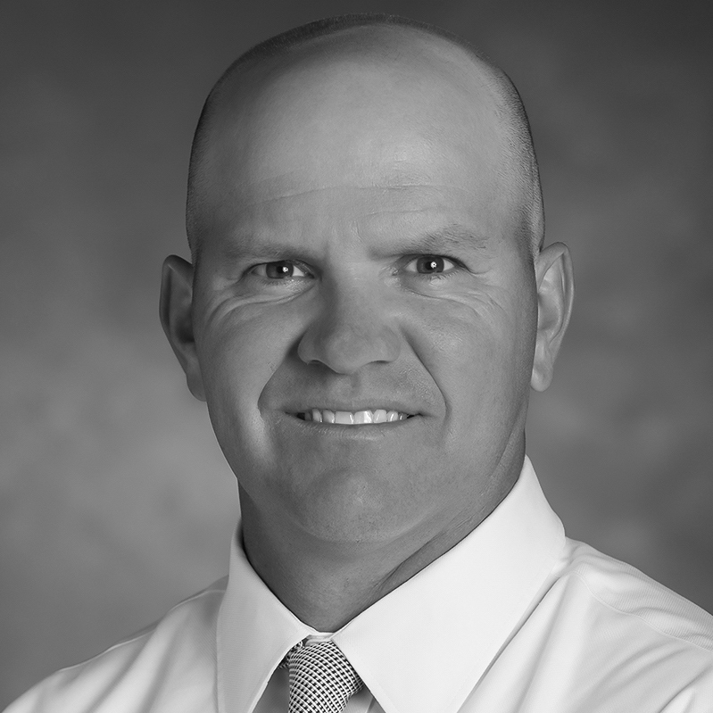 Smiling bald man in white shirt and tie