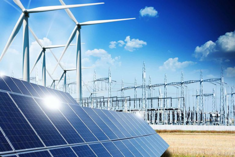 Solar panels with wind turbines and electricity pylons