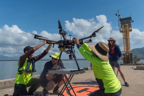 4 people launching drone